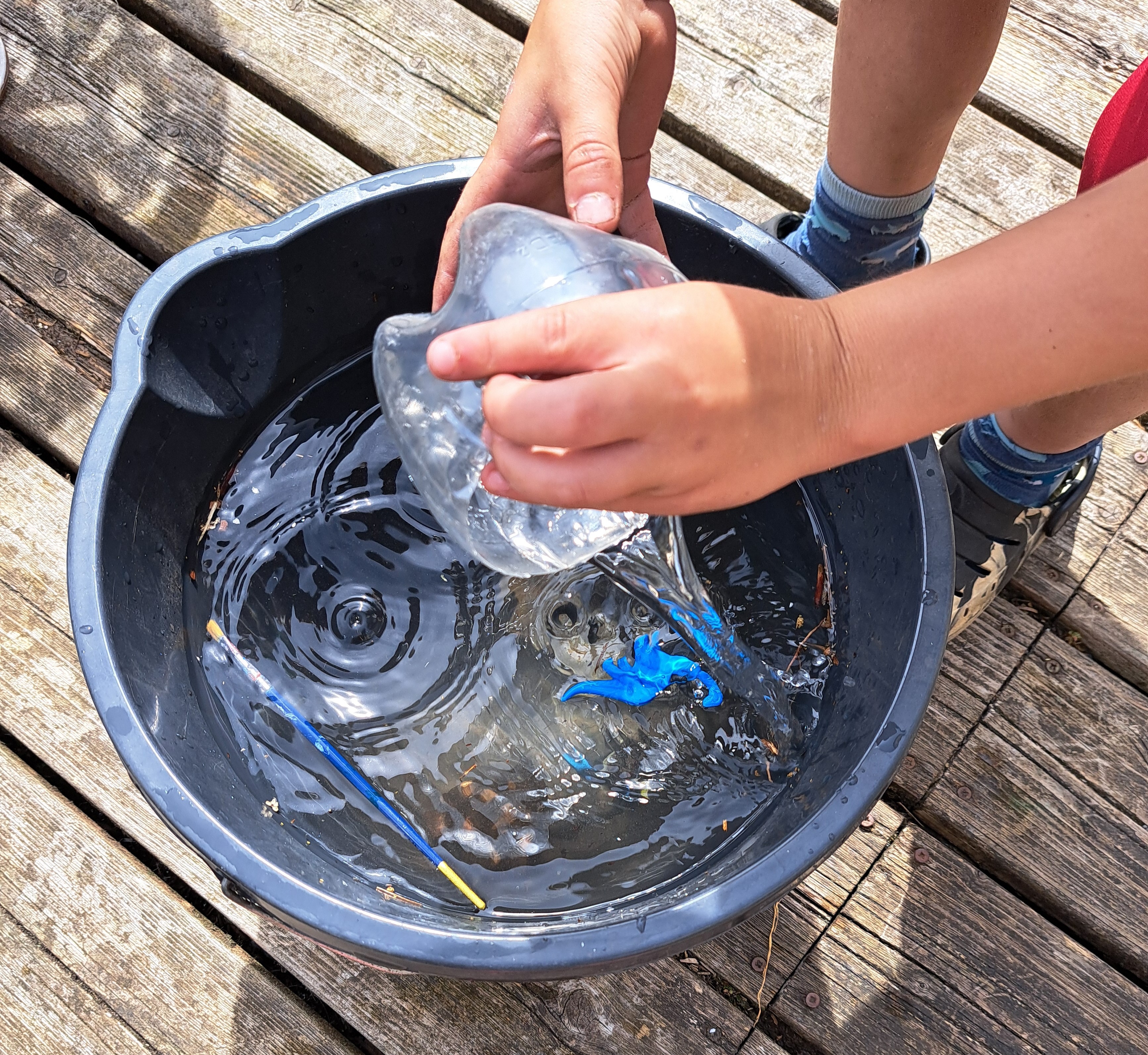 Floating paintbrush, bottle bottom and sunked rock in Sink or Float Activity